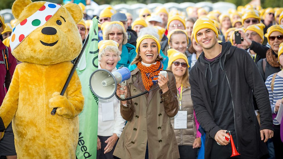 Large group of fundraisers in Countryfile hats with Pudsey and two celebrities