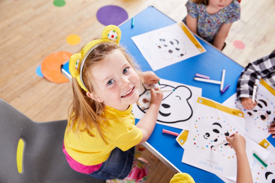 nursery child colouring in a pudsey mask