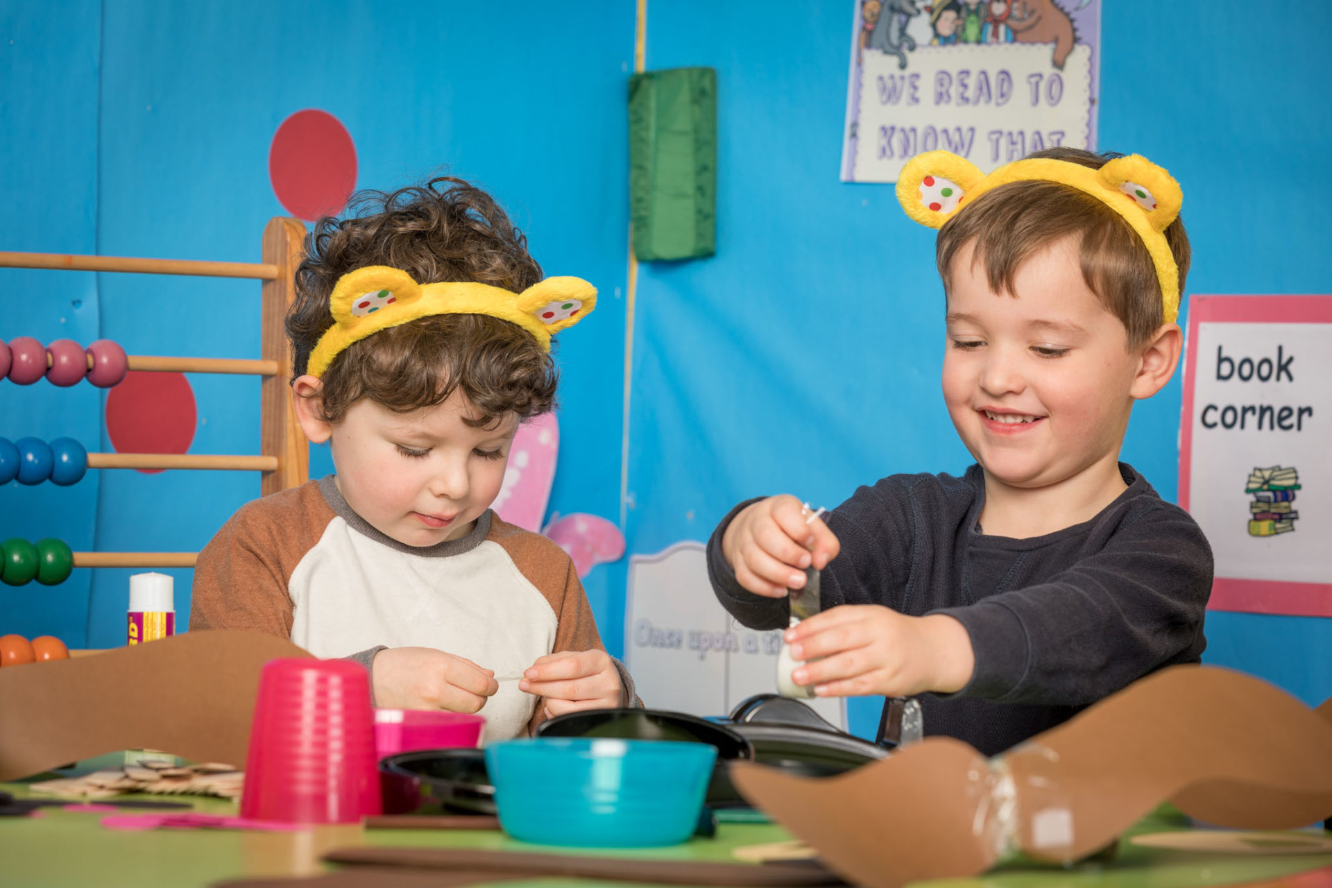 Two young boys in Pudsey ears making a mask