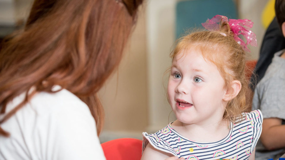 Young girl excited with a female volunteer