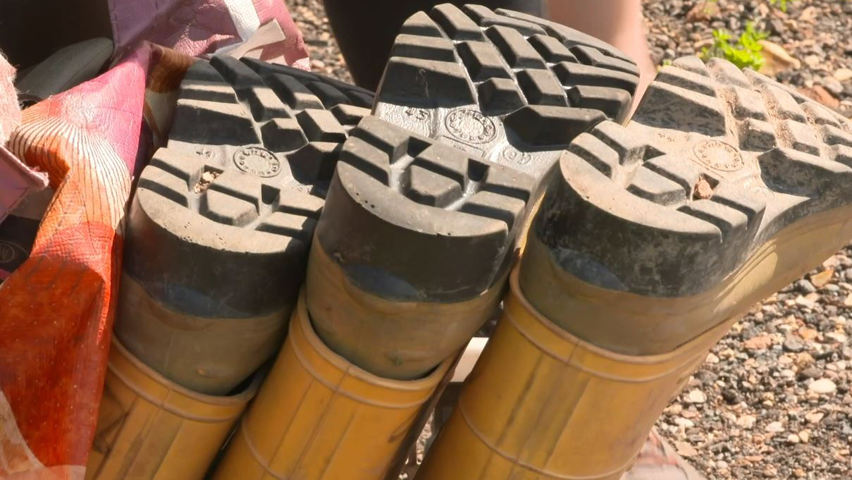 Three brown welly boots upside down in a row