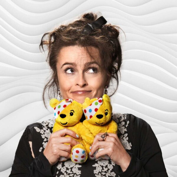 Helen Bonham Carter holding two small Pudsey toys