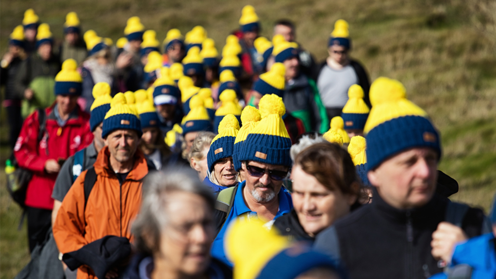 A group of people hiking wearing Countryfile bobble hats