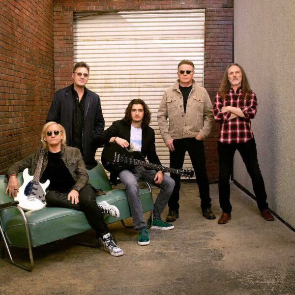 the Eagles in a stylised room looking to camera