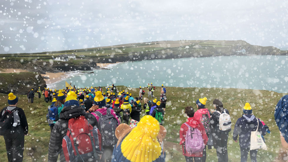 a snowy walk in the countryside with ramblers wearing countryfile haats