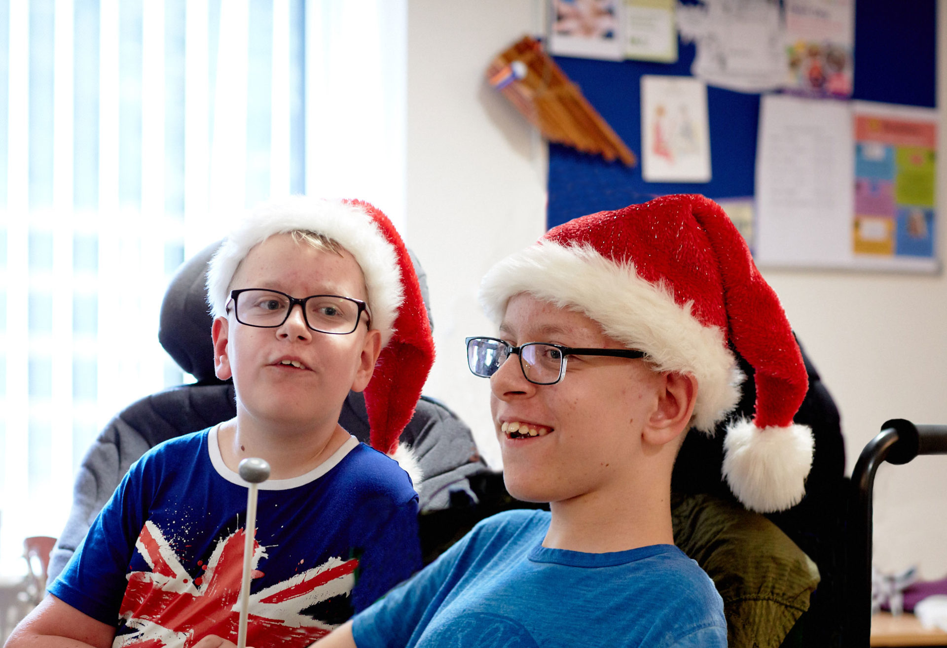 Sam and Alex wearing Santa hats