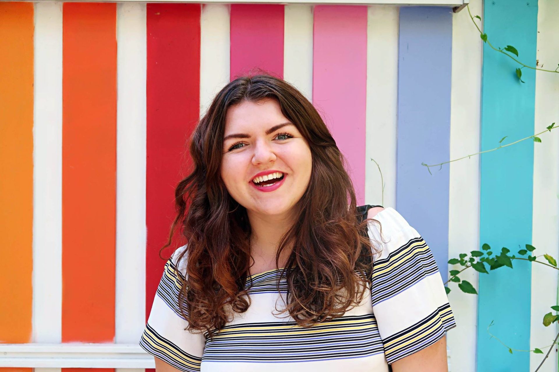 Colette in front of a colourful background