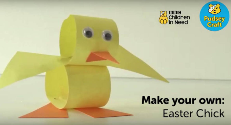 A picture of the final Easter chick made from yellow and orange paper and with googly eyes