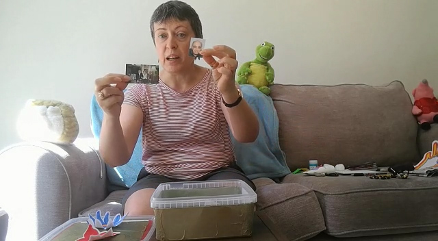 Jane holding a photo and a shell