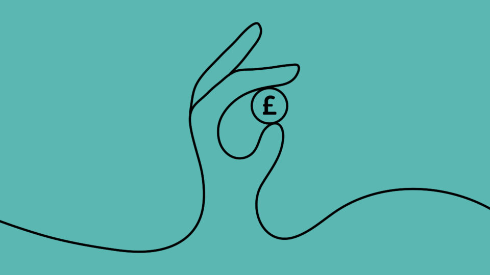 a hand holding a coin