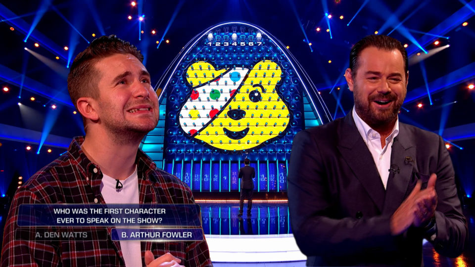 Contestants looking The Wall with a Pudsey head graphic