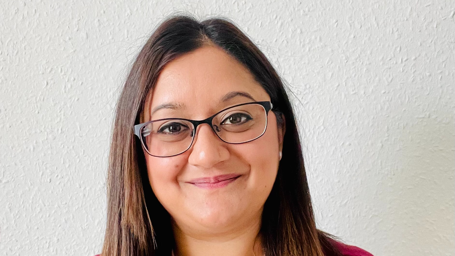 Lisa Patel smiling against a plain background