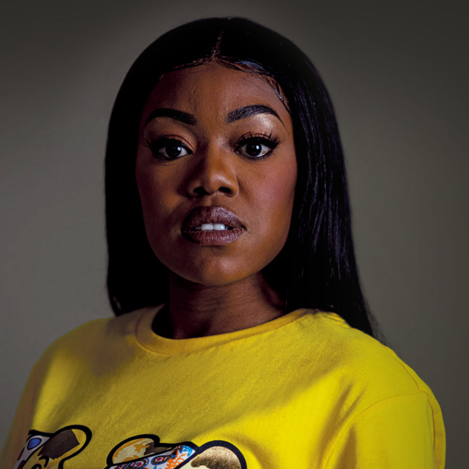 A headshot of Lady Leshurr looking at the camera