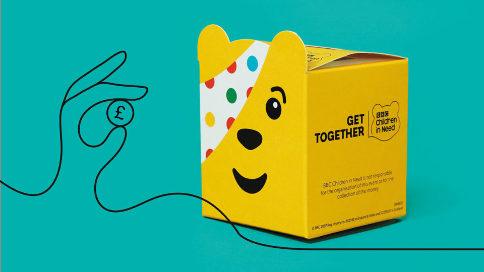 A picture of yellow cardboard Pudsey moneybox