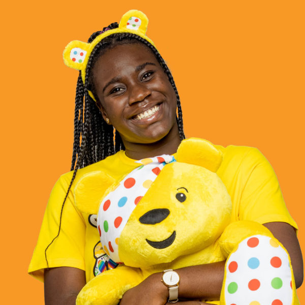 Ore holding a pudsey bear toy and wearing pudsey ears