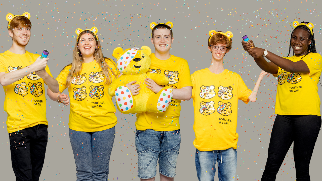 The members of the Surprise Squad in yellow Pudsey Bear t-shirts with confetti