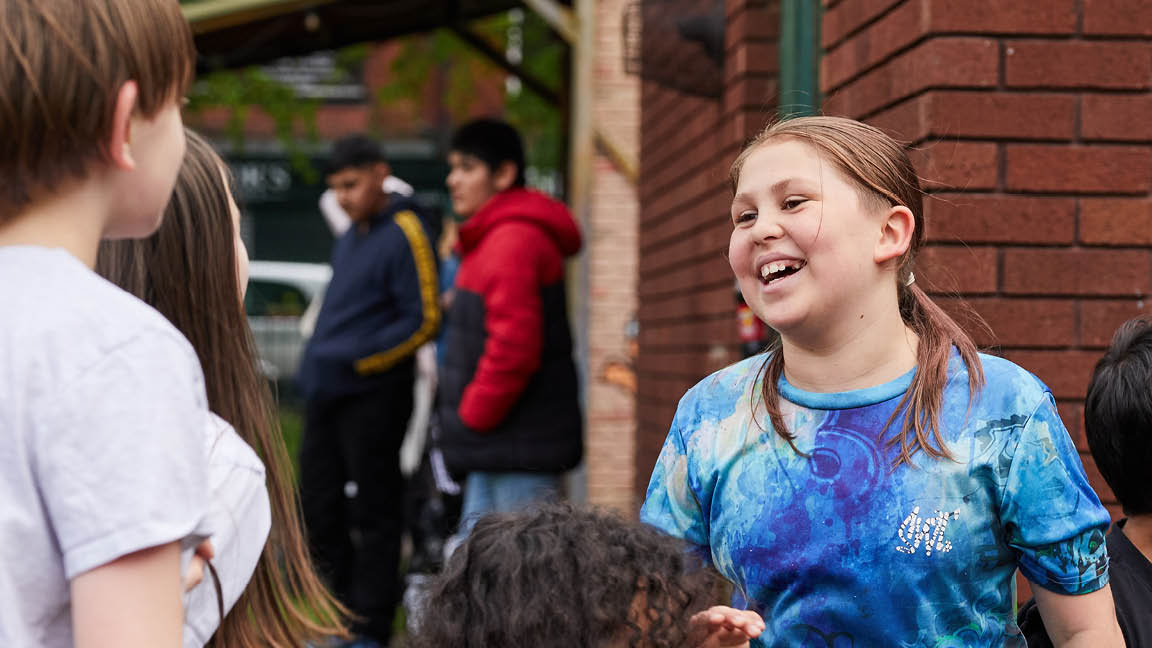 a child smiling with friends