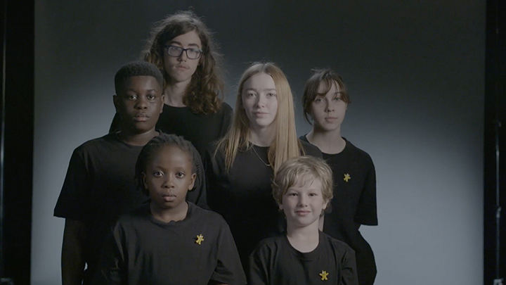 A group of children wearing black t shirts and Pudsey pin badges