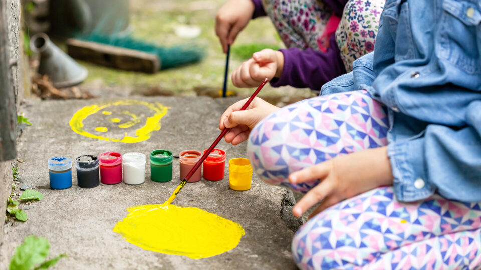children painting on a flagstone floor