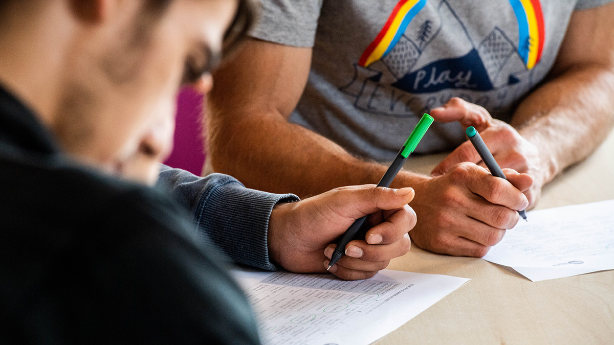 A child and adult writing together