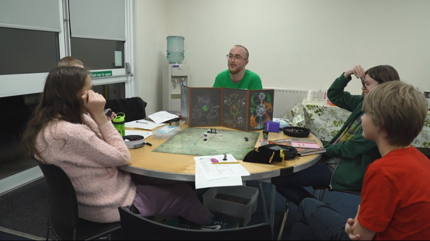 Young people playing dungeons and dragons at a table