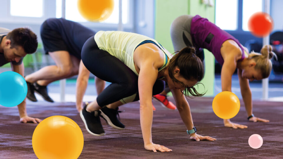 A group of people take part in an exercise class surrounded by coloured yellow spots which appear to float in the air around them