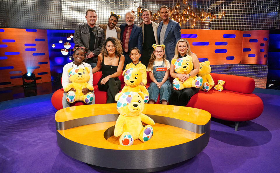 Graham norton and guests surround a Pudsey bear