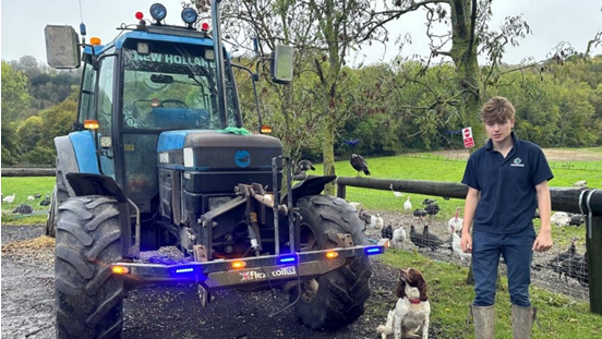 Henry next to a tractor
