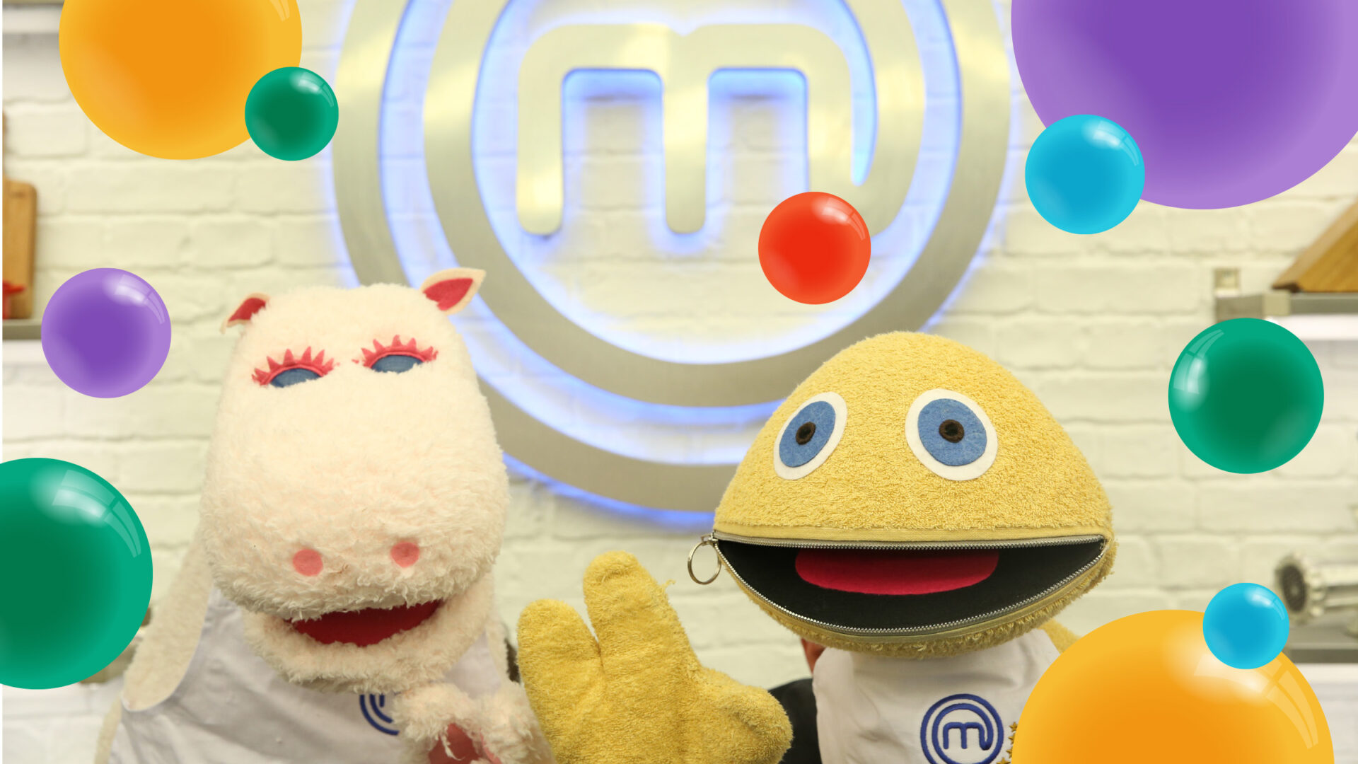 George and Zippy in front of the masterchef logo