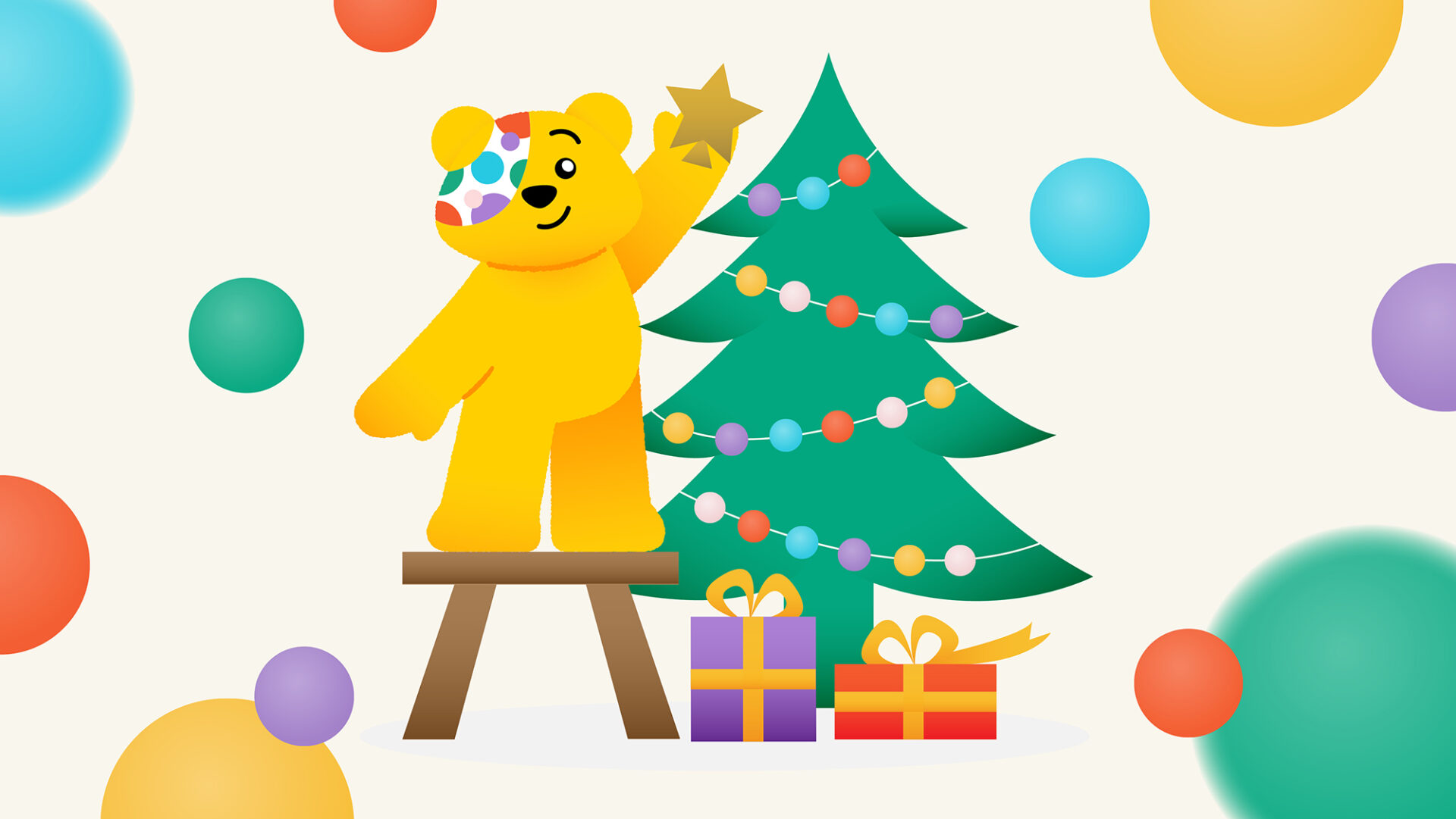 Pudsey placing a start on top of a christmas tree