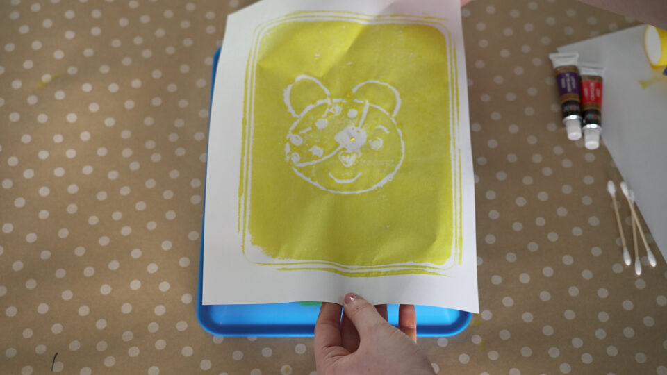 a piece of paper being printed with yellow ink