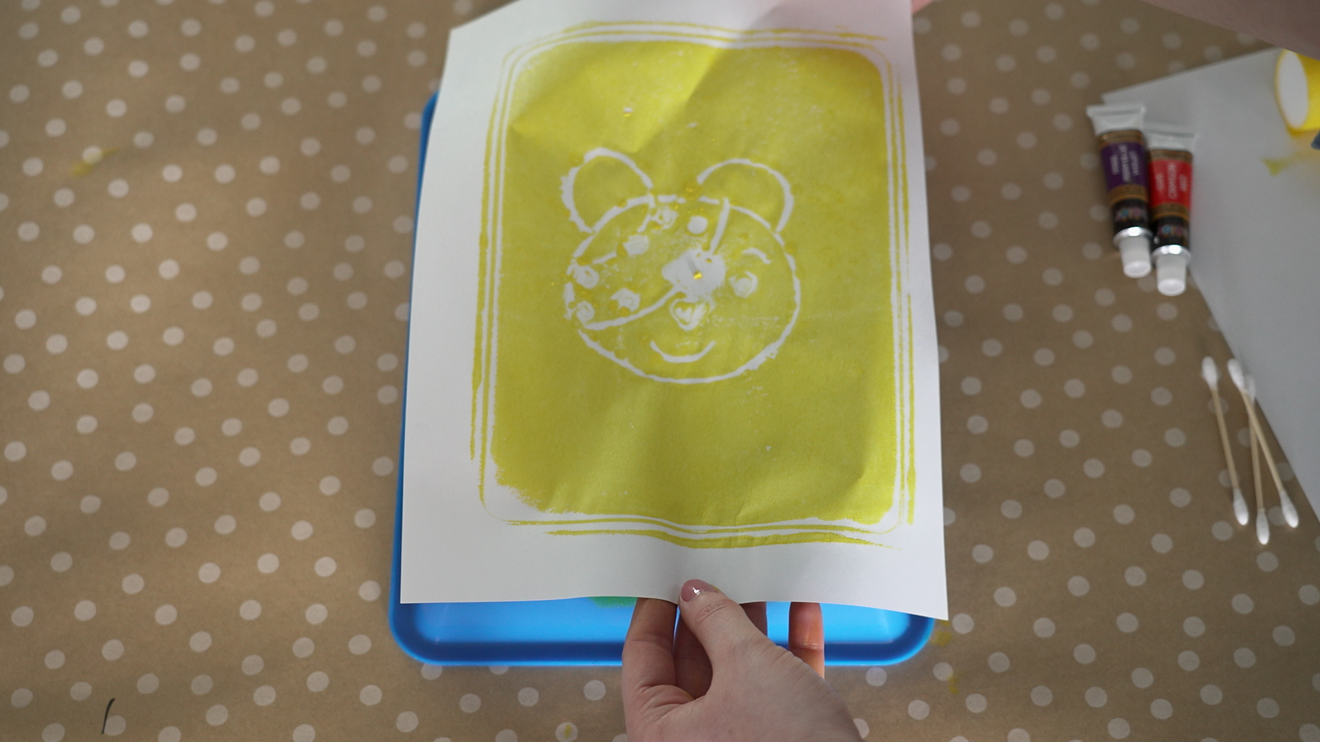 a piece of paper being printed with yellow ink