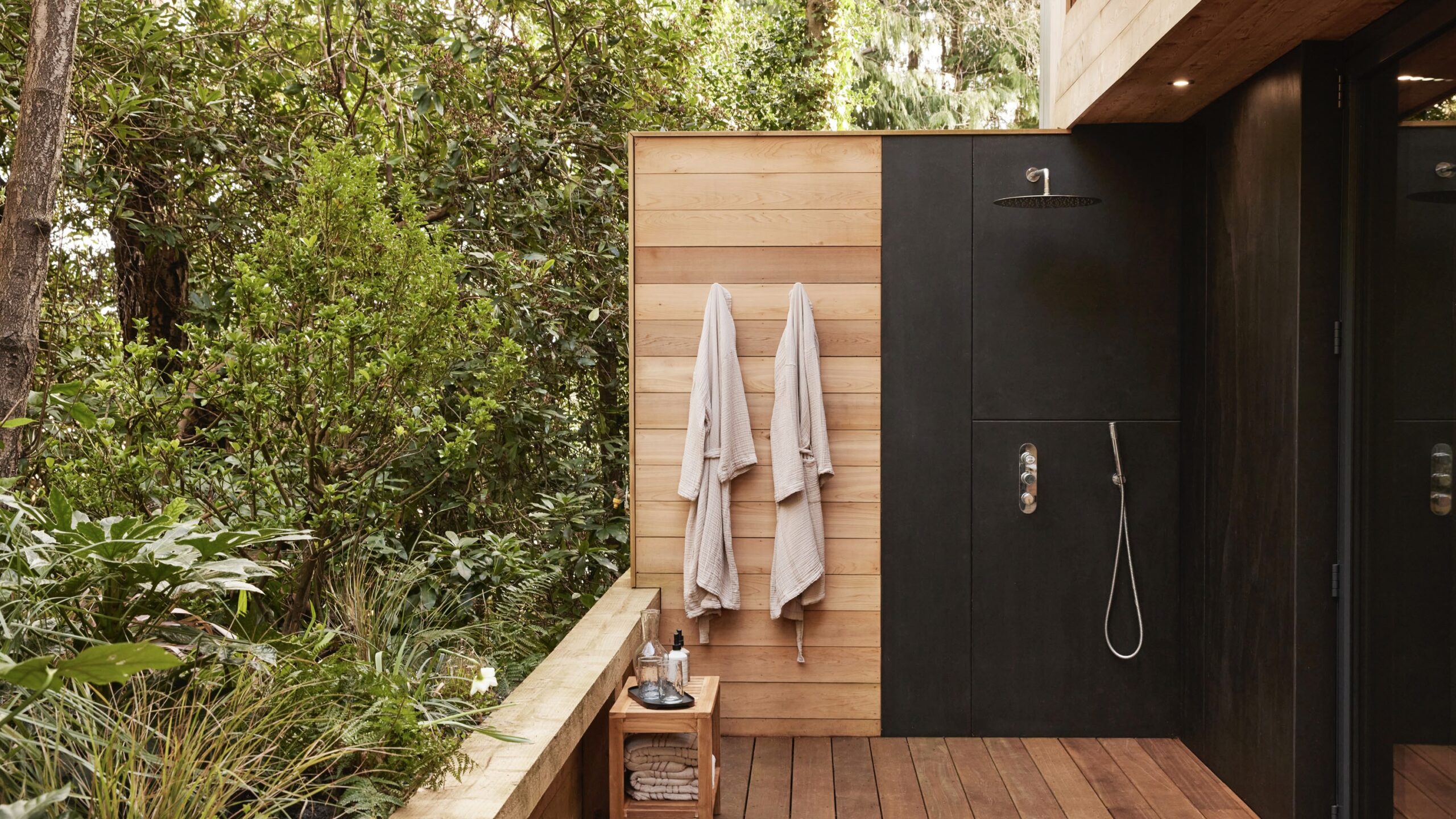 A black and wooden modern house- an outdoor shower