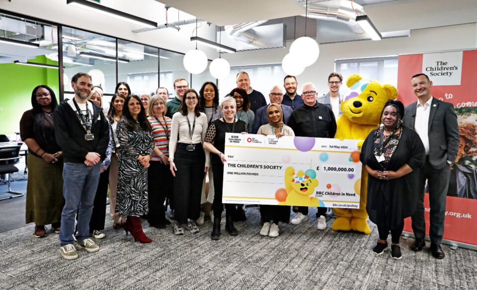 A group of staff from The Children's Society accepting a million pound cheque from BBC Children in Need