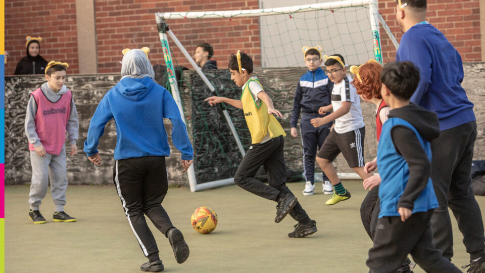 children playing football wearing Pudsey style yellow ears
