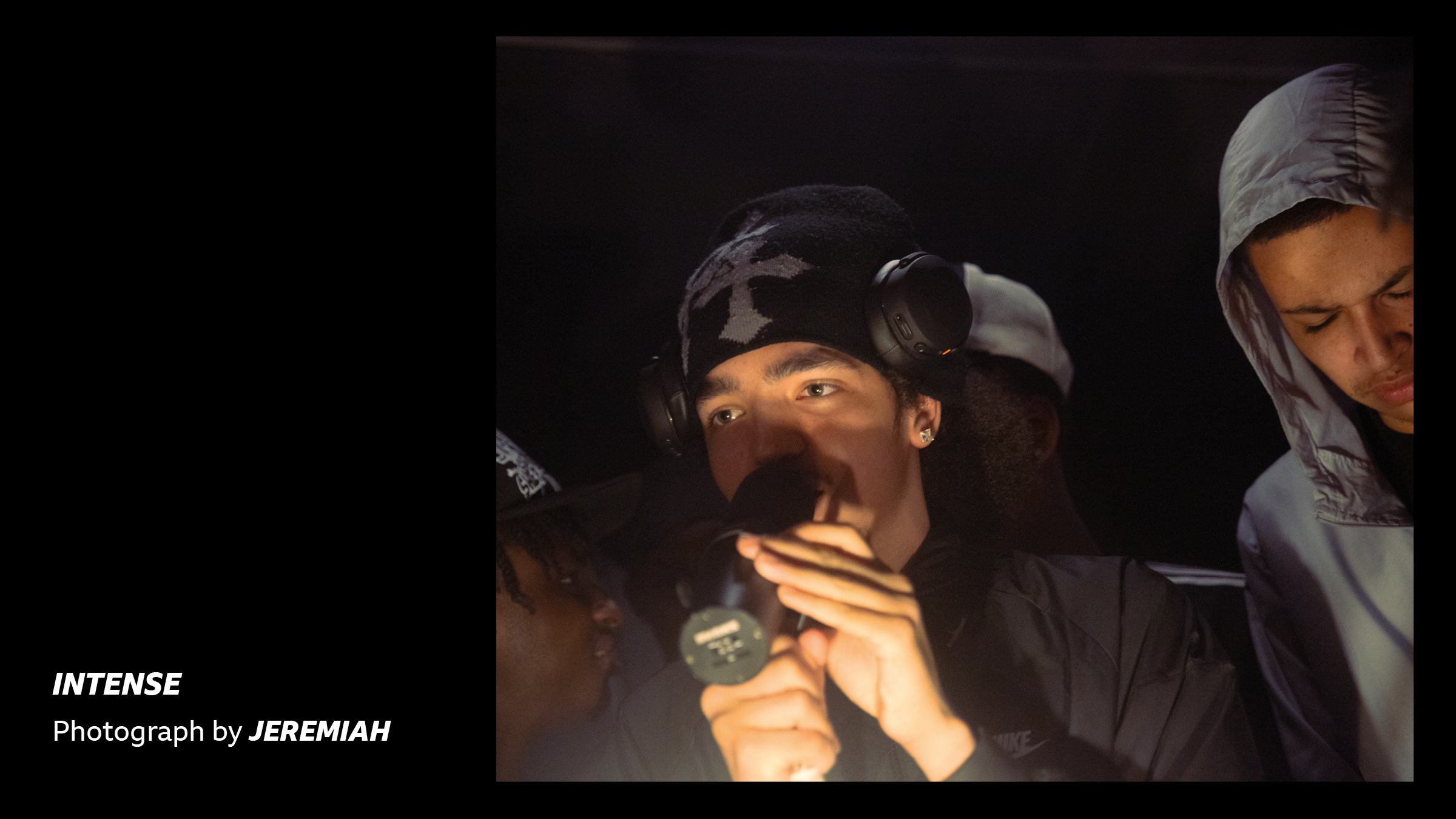 'Intense - Photograph by Jeremiah' - a young person rapping in a dark room