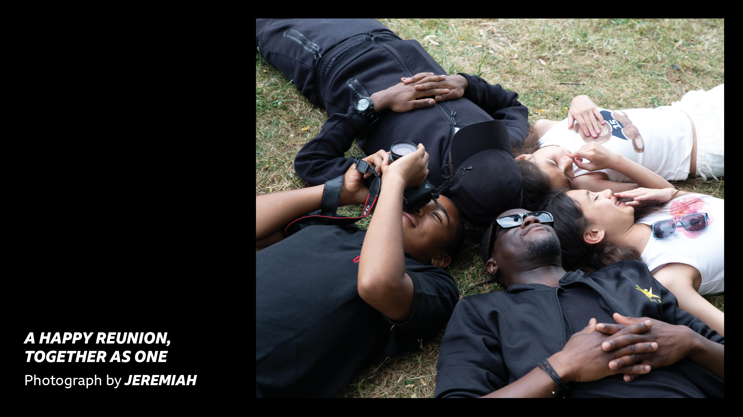 'A Happy Reunion Together as One - Photograph by Jeremiah' - A group of young people lying on the grass smiling and looking up at the sky