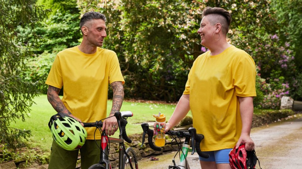 Two people cycling in yellow t-shirts