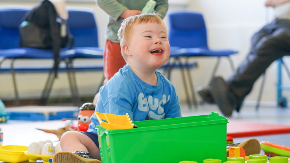 A child smiling playing with toys