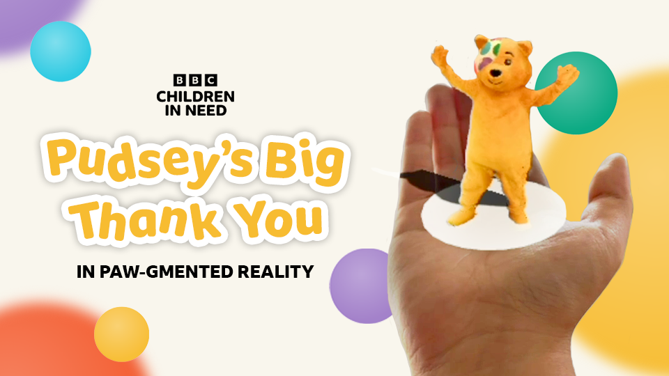 An animated Pudsey stood on the palm of a person with title 'Pudsey's Big Thank You in Pawgmented Reality'