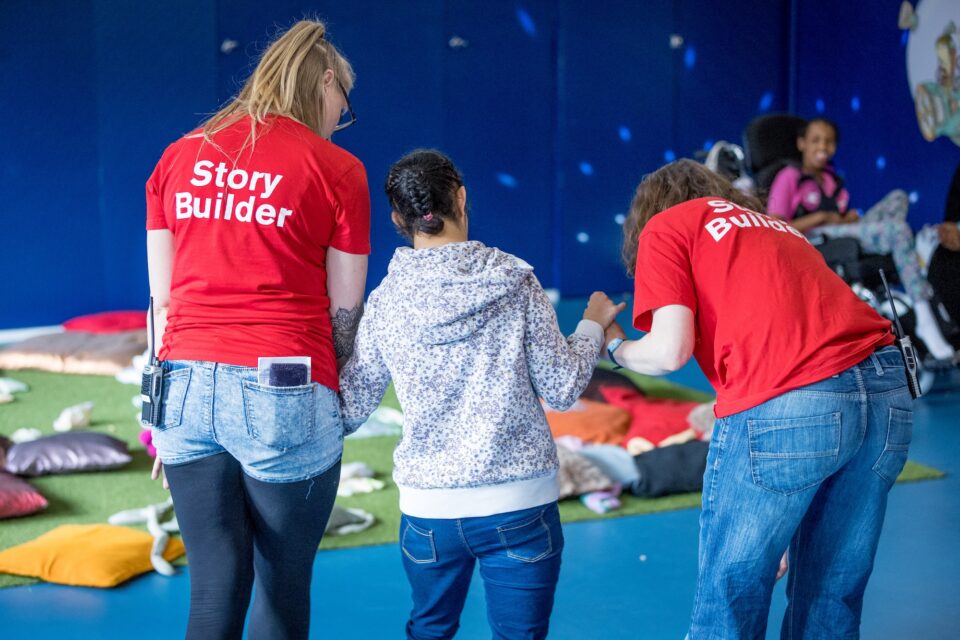 A young person being supported by two project workers
