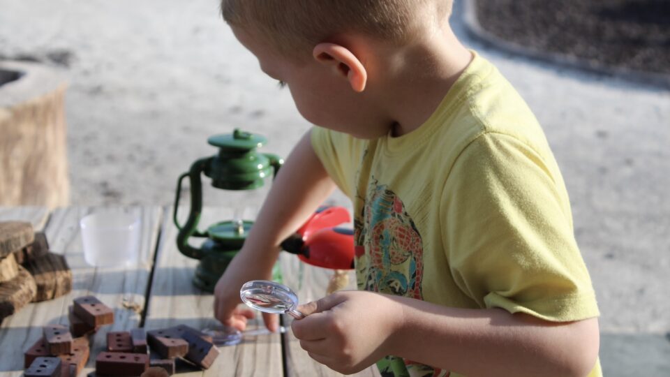 A young child sat playing with toys