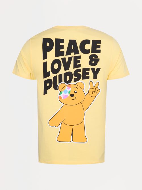 A yellow T shirt with the words Peace Love and Pudsey and Pudsey Bear holding up two fingers in a peace sign