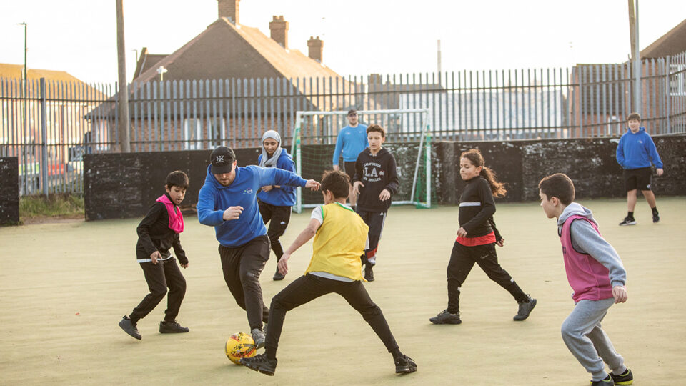 children playing football outside